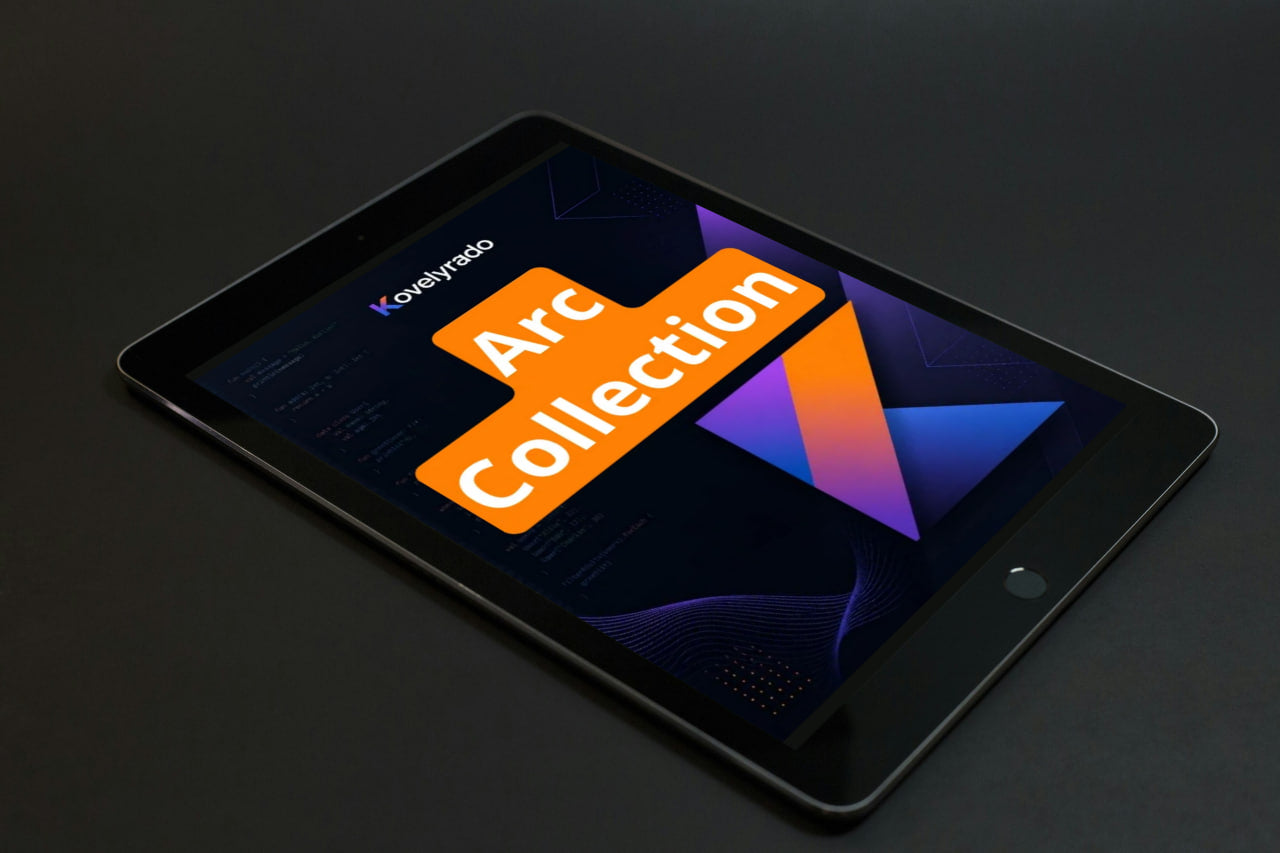 A black tablet device shown at an angle on a dark surface, displaying a colorful screen with the text 'Koyepino Arc Collection'.