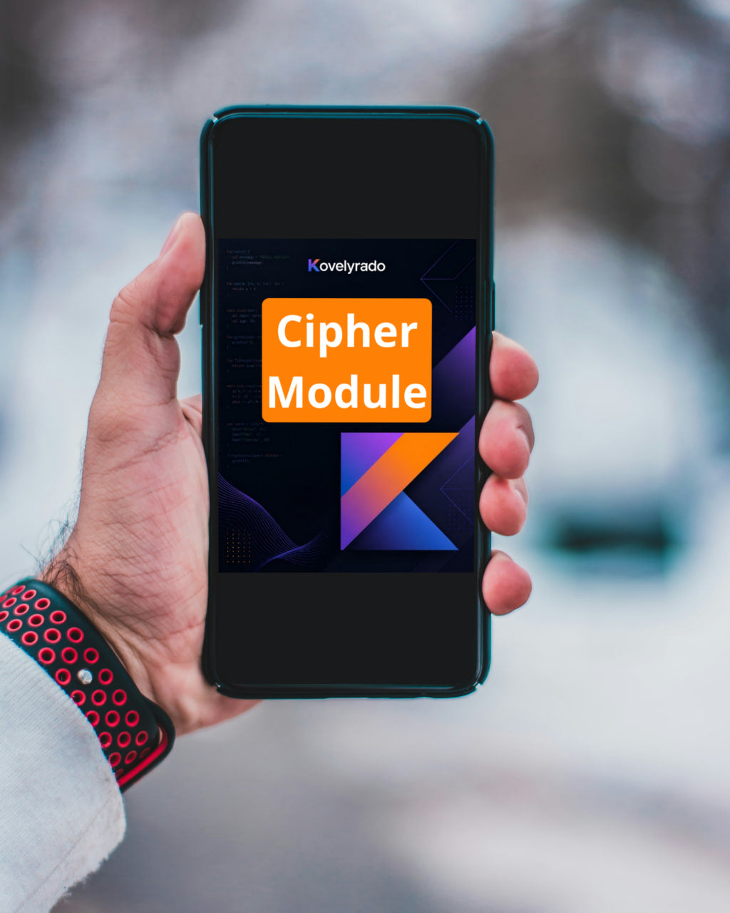 A hand holding a smartphone with a dark screen displaying the 'Kovelyrado Cipher Module' logo, set against a blurred outdoor background.