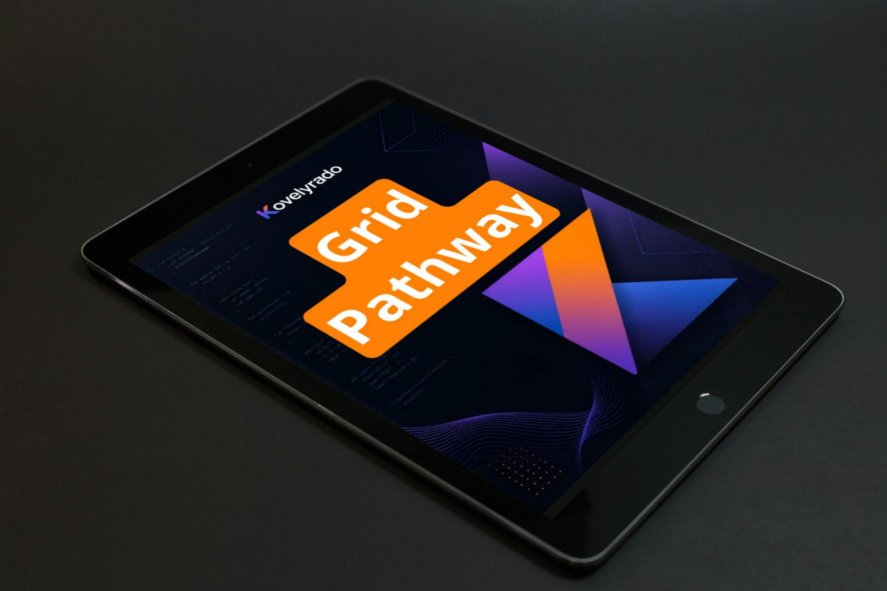 A black tablet device shown at an angle on a dark surface, displaying a colorful screen with the text 'Koyepino Grid Pathway' and geometric graphics.