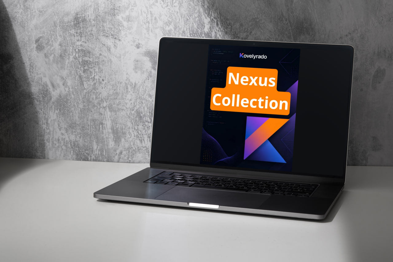 A silver laptop sits open on a white tabletop against a textured gray wall. The screen displays a digital cover for 'Kovelrado Nexus Collection' with orange and purple geometric graphics.