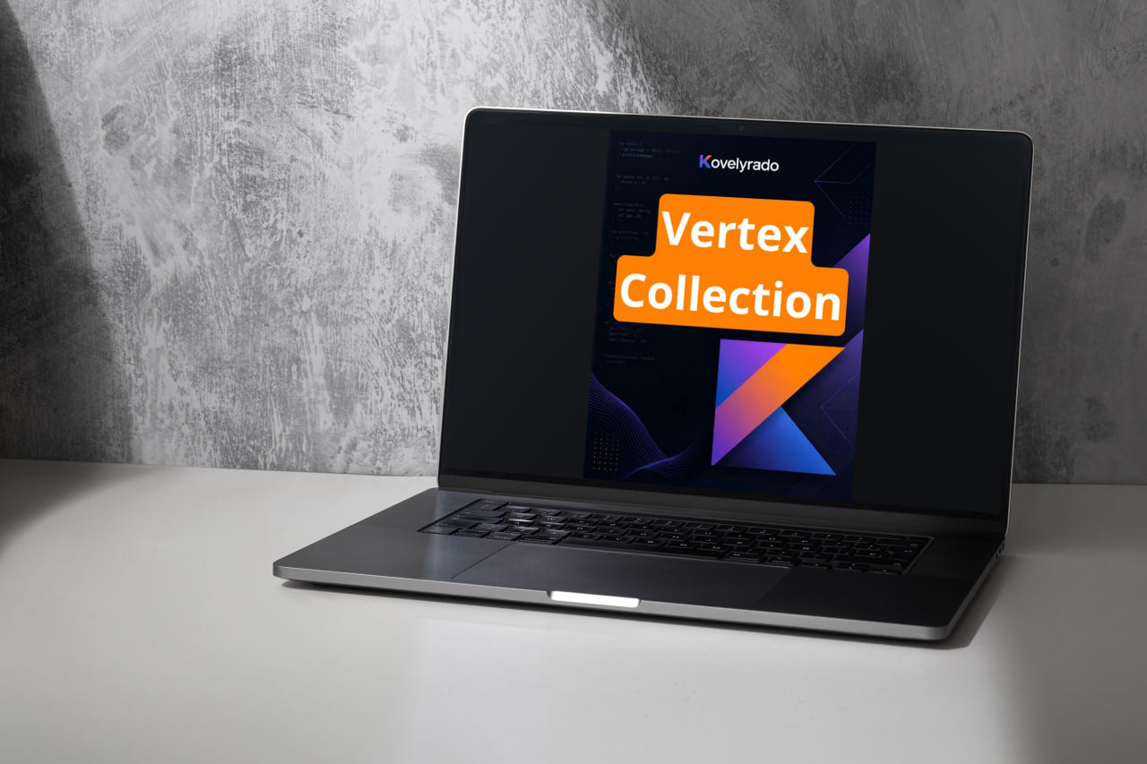A silver laptop sits open on a white tabletop against a textured gray wall, displaying a digital cover for 'Kovelirato Vertex Collection' with orange and purple geometric graphics on the screen.
